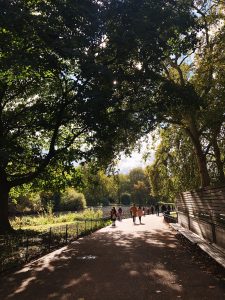 People walking and talking at a London park.